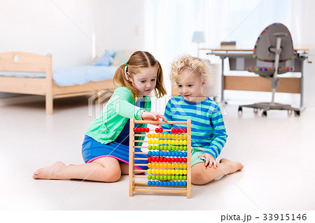 Kids playing with wooden abacus. Educational toy. Kids playing with wooden abacus. Educational toy. 33915146
