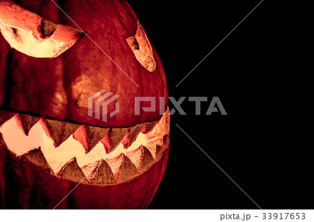 Side view halloween pumpkin burning eyes mouth 33917653