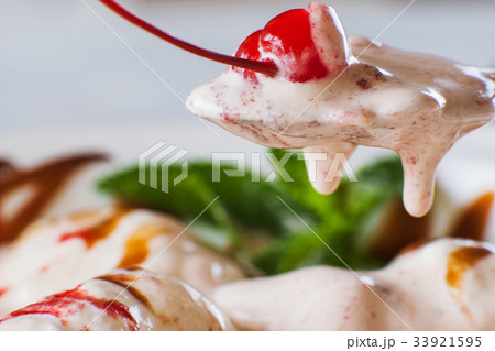 Sweet icecream melting away in spoon 33921595