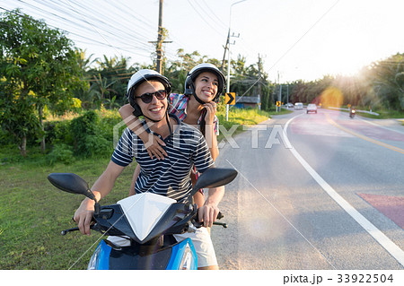 Happy Couple Riding Motorcycle In Countryside 33922504