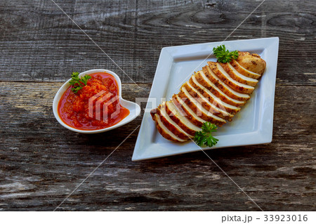 Grilled Chickenbreast with Red Spicy adjika Sauce 33923016