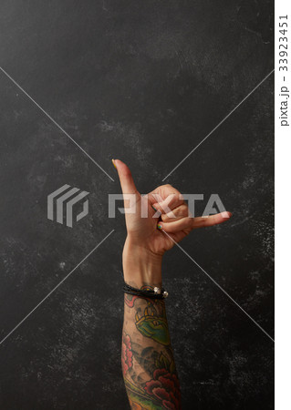 Beautiful woman's hand with tattoos 33923451