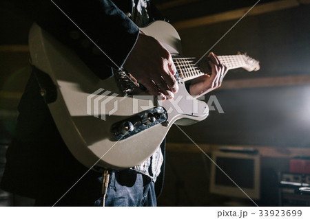Playing electric guitar in studio closeup 33923699
