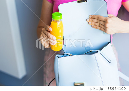 Young woman holding a bottle with juice 33924100