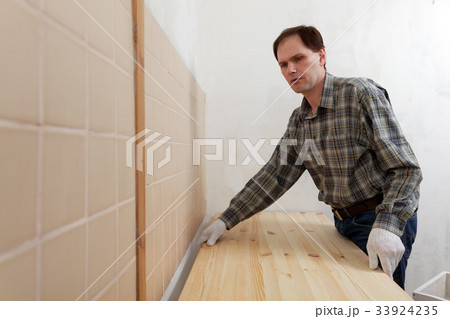 Worker installing a countertop Worker installing a countertop 33924235