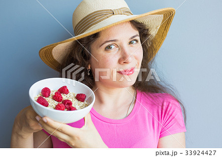 Smiling woman hold healthy and natural breakfast 33924427