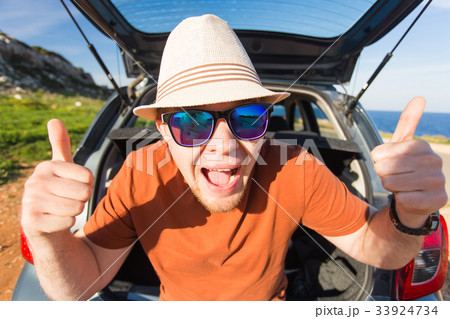 Funny happy man going on summer vacation. Car Funny happy man going on summer vacation. Car 33924734