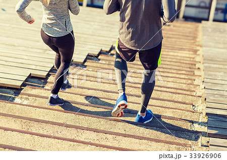 close up of couple running downstairs on stadium 33926906