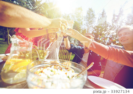 happy friends with drinks at summer garden party happy friends with drinks at summer garden party 33927134