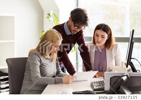 happy business team with papers in office 33927135
