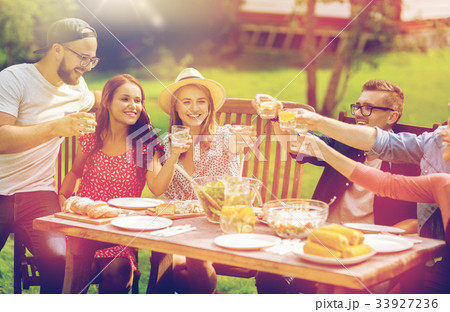 happy friends having dinner at summer garden party happy friends having dinner at summer garden party 33927236