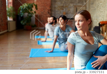 group of people doing yoga exercises at studio 33927331