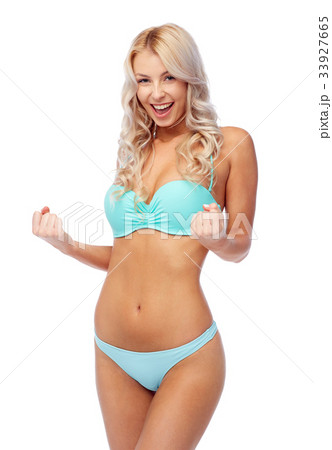 happy young woman in bikini doing fist pump 33927665