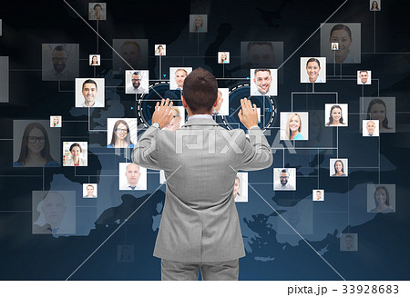 businessman using virtual screen with contacts businessman using virtual screen with contacts 33928683