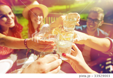 happy friends with drinks at summer garden party happy friends with drinks at summer garden party 33929003