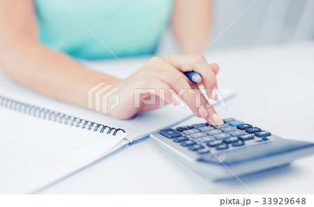 businesswoman working with calculator in office 33929648