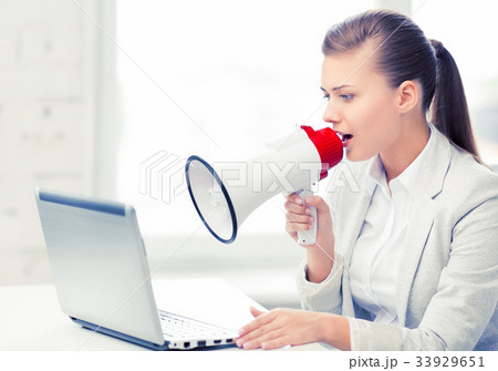 strict businesswoman shouting in megaphone 33929651