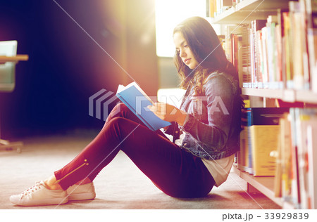 high school student girl reading book at library high school student girl reading book at library 33929839