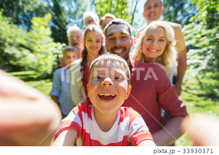 happy family taking selfie in summer garden happy family taking selfie in summer garden 33930371
