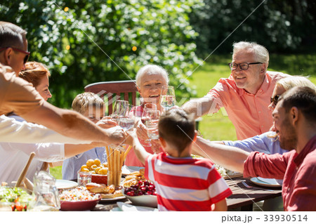 happy family having dinner or summer garden party 33930514