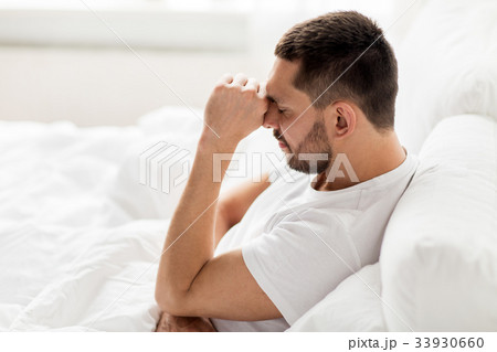 stressed man in bed at home stressed man in bed at home 33930660