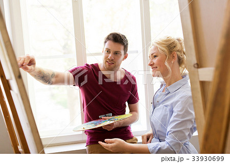 artists with palette and easel at art school 33930699