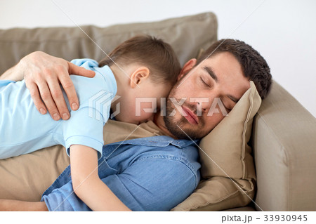 happy father and son sleeping on sofa at home happy father and son sleeping on sofa at home 33930945