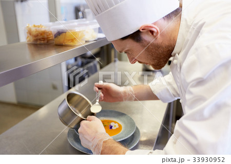 happy male chef cooking food at restaurant kitchen 33930952