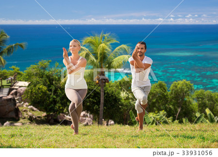 smiling couple making yoga exercises outdoors 33931056