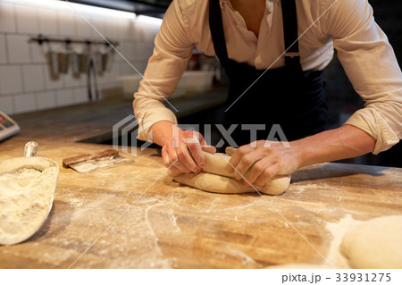 chef or baker cooking dough at bakery chef or baker cooking dough at bakery 33931275