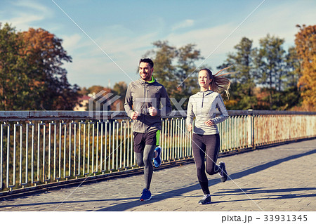 happy couple running outdoors happy couple running outdoors 33931345