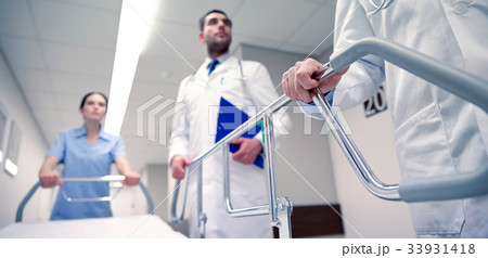 medics carrying hospital gurney to emergency 33931418