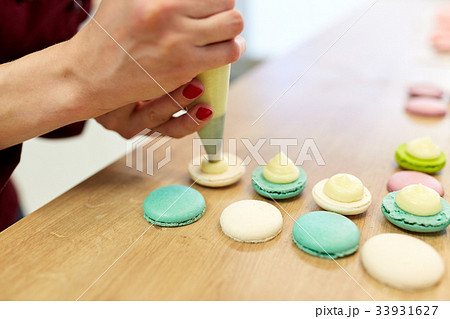 chef with injector squeezing filling to macarons chef with injector squeezing filling to macarons 33931627