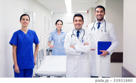 group of happy doctors with gurney at hospital group of happy doctors with gurney at hospital 33931660