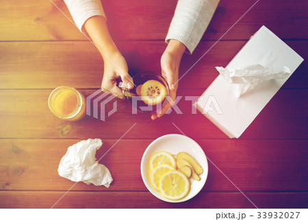 ill woman drinking tea with lemon and ginger ill woman drinking tea with lemon and ginger 33932027