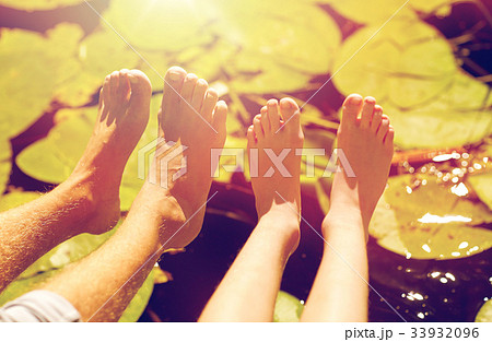 grandfather and grandson feet over river 33932096