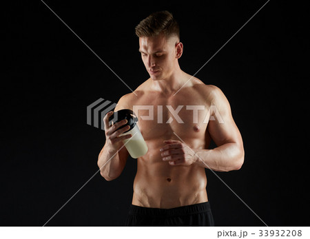 young man or bodybuilder with protein shake bottle 33932208