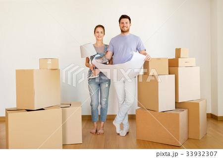 couple with boxes and blueprint moving to new home couple with boxes and blueprint moving to new home 33932307
