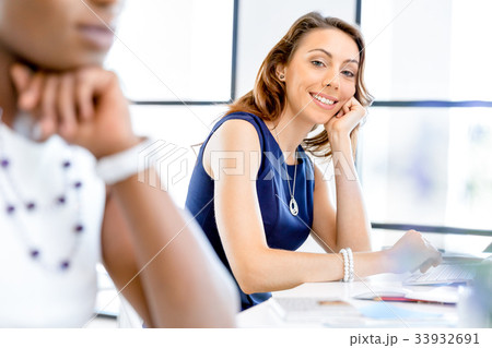 Young businesswoman sitting at desk and working 33932691