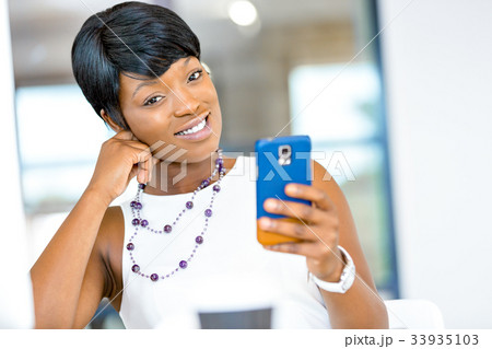 Portrait of smiling business woman with mobile 33935103