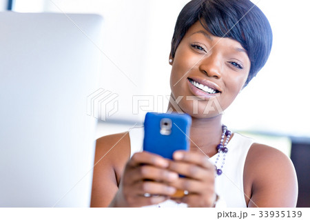 Portrait of smiling business woman with mobile 33935139