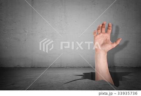 A large male hand forcing its way through a hole A large male hand forcing its way through a hole 33935736