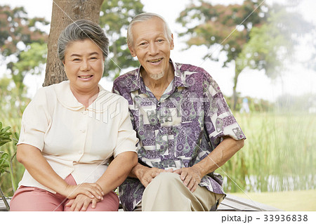 A picture of an old couple sitting and smiling happily A picture of an old couple sitting and smiling happily 33936838