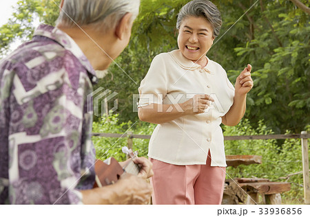 An elderly woman is looking at her husband and smiling happily An elderly woman is looking at her husband and smiling happily 33936856