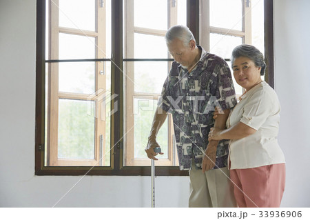 grand mother is looking after her husband on bed 33936906