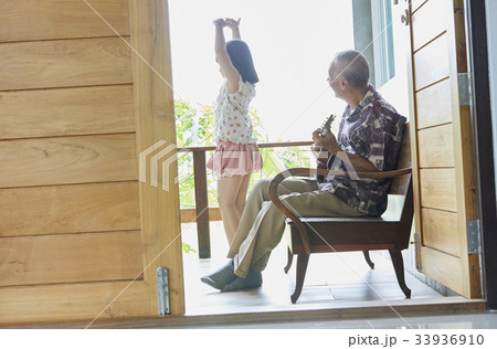 a woman is smiling and holding hand of a man who is sleeping 33936910