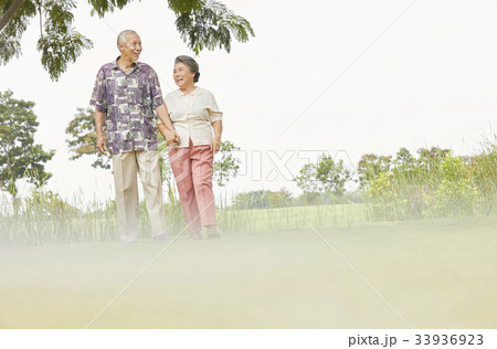 asian nurse is helping and supporting old man with walking cane 33936923