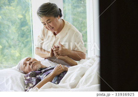 a photo of old grand mother helping her husband walking upstairs a photo of old grand mother helping her husband walking upstairs 33936925