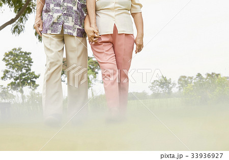 two elderly people are sitting chatting together inside house 33936927