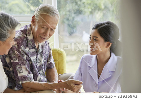 a nurse is showing something for elderly man a nurse is showing something for elderly man 33936943